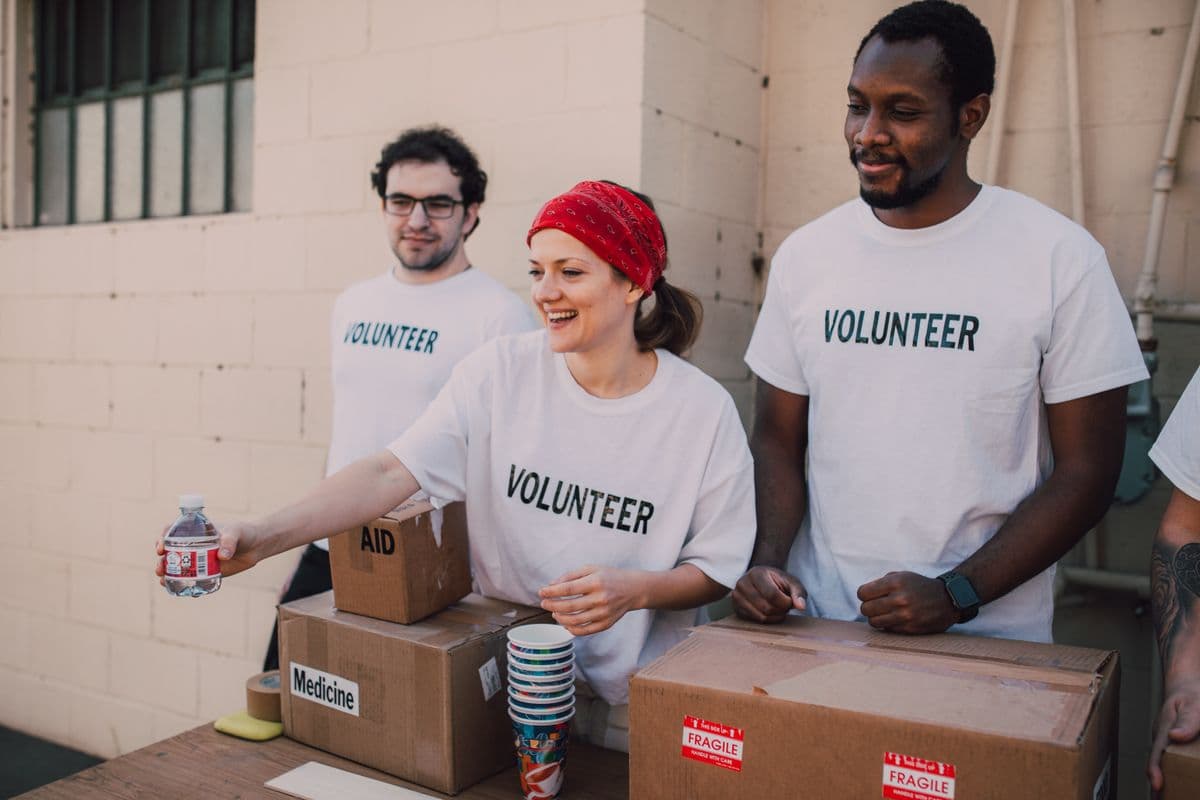 Volunteers distributing food and supplies at a community event
