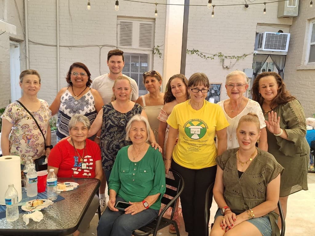HHI community members gathered at a neighborhood health event wearing Hispanic Health Initiatives shirts